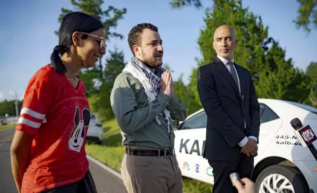 Palestinian activist Mahmoud Khalil, center, speaks after his release from federal immigration detention in Jena, La., Friday, June 20, 2025. (AP Photo/Matthew Hinton)