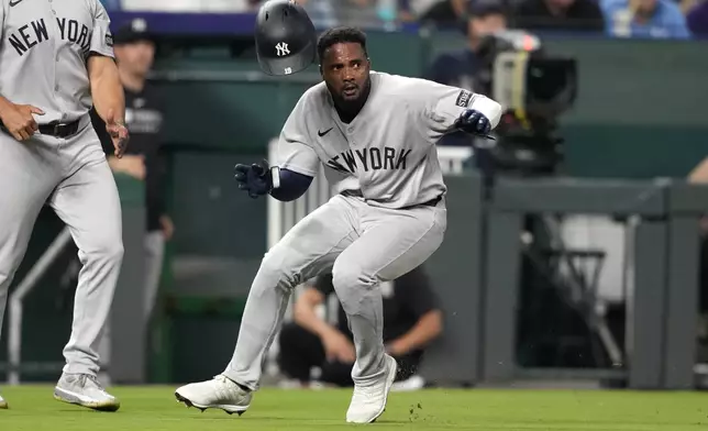 New York Yankees' Pablo Reyes, right, runs home to score in the eighth inning of a baseball game against the Kansas City Royals, Thursday, June 12, 2025, in Kansas City, Mo. (AP Photo/Ed Zurga)