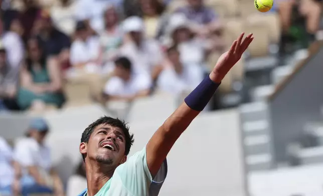 Australia's Alexei Popyrin serves against Tommy Paul of the U.S. during their fourth round match of the French Tennis Open, at the Roland-Garros stadium, in Paris, Sunday, June 1 2025. (AP Photo/Lindsey Wasson)