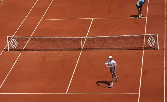 Tommy Paul of the U.S. reacts winning a point to Australia's Alexei Popyrin, top right, during their fourth round match of the French Tennis Open, at the Roland-Garros stadium, in Paris, Sunday, June 1 2025. (AP Photo/Lindsey Wasson)
