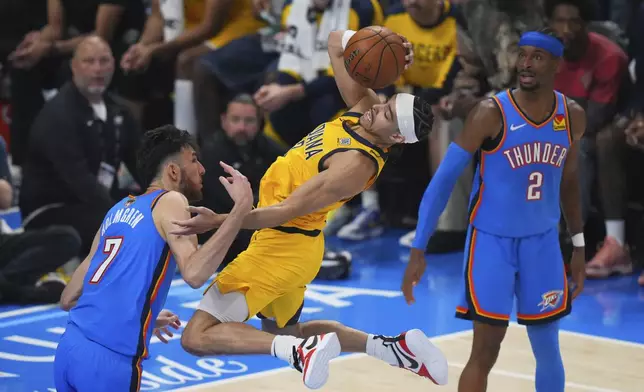 Oklahoma City Thunder forward Chet Holmgren (7) fouls Indiana Pacers guard Andrew Nembhard, center, during the second half of Game 7 of the NBA Finals basketball series Sunday, June 22, 2025, in Oklahoma City. (AP Photo/Nate Billings)