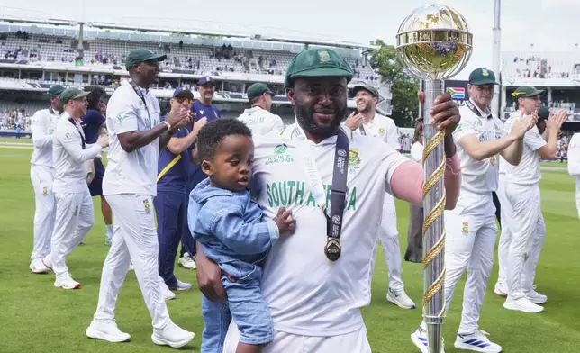 South Africa's captain Temba Bavuma holds the winner's trophy after their win in the World Test Championship final against Australia at Lord's cricket ground in London, Saturday, June 14, 2025. (AP Photo/Kirsty Wigglesworth)