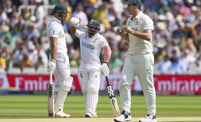 South Africa's captain Temba Bavuma, center, chats with batting partner Aiden Markram between overs on day four of the World Test Championship final between South Africa and Australia at Lord's cricket ground in London, Saturday, June 14, 2025. (AP Photo/Kirsty Wigglesworth)