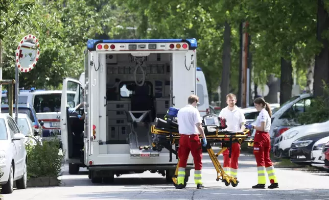 Rescue service personnel attend the scene of a shooting at a school in Graz, Austria, Tuesday, June 10, 2025. (Kleine Zeitung via AP)