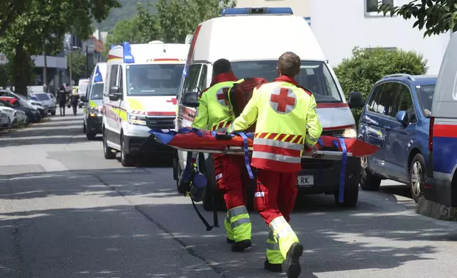 Rescue service personnel attend the scene of a shooting at a school in Graz, Austria, Tuesday, June 10, 2025. (Kleine Zeitung via AP)