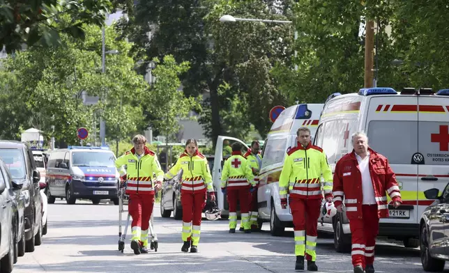 Rescue service personnel attend the scene of a shooting at a school in Graz, Austria, Tuesday, June 10, 2025. (Kleine Zeitung via AP)