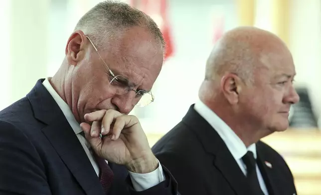 Austrian Interior Minister Gerhard Karner, left, and Chancellor Christian Stocker, right, attend a news conference following a shooting at a school in Graz, Austria, Tuesday, June 10, 2025. (AP Photo/Heinz-Peter Bader)
