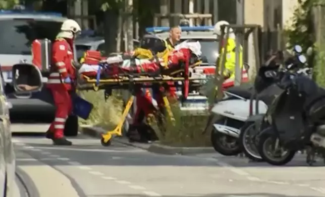 In this image made from video provided by Servus TV, police at the scene of a shooting at a school in Graz, Austria, Tuesday, June 10, 2025. (Servus TV via AP)