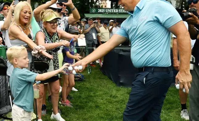 Padragh Harrington, right, hands a ball to Jackson Annen after winning the U.S. Senior Open golf championship at the Broadmoor Golf Club, Sunday, June 29, 2025, in Colorado Springs, Colo. (Jerilee Bennet/The Gazette via AP)