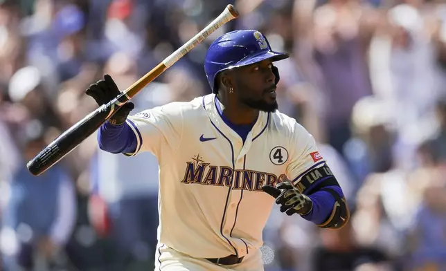 Seattle Mariners' Randy Arozarena watches his walkoff single that scored Julio Rodriguez during the ninth inning of a baseball game against the Minnesota Twins, Sunday, Jun 1, 2025, in Seattle. (AP Photo/Ryan Sun)