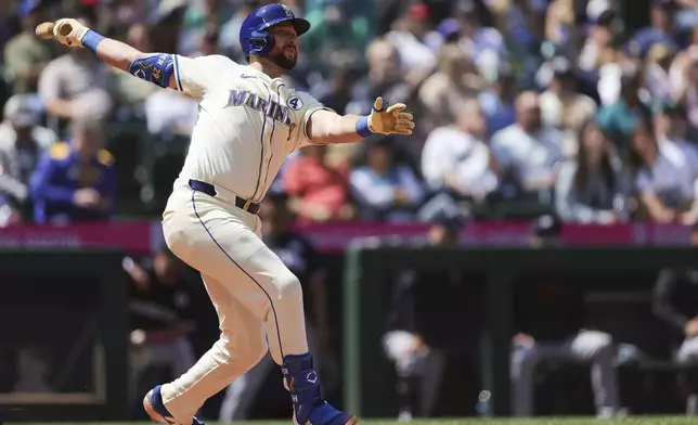 Seattle Mariners' Cal Raleigh watches his solo home run during the seventh inning of a baseball game against the Minnesota Twins, Sunday, Jun 1, 2025, in Seattle. (AP Photo/Ryan Sun)
