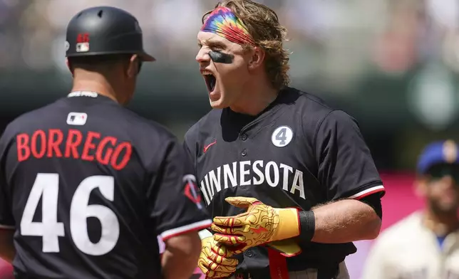 Minnesota Twins' Harrison Bader, right, reacts next to Ramon Borrego (46) after grounding out to end the top of the seventh inning of a baseball game against the Seattle Mariners, Sunday, Jun 1, 2025, in Seattle. (AP Photo/Ryan Sun)