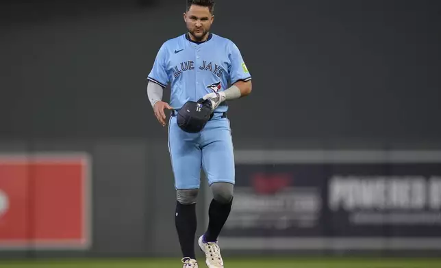 Toronto Blue Jays' Bo Bichette (11) walks back to the dugout after being caught stealing second base during the seventh inning of a baseball game against the Minnesota Twins, Friday, June 6, 2025, in Minneapolis. (AP Photo/Abbie Parr)