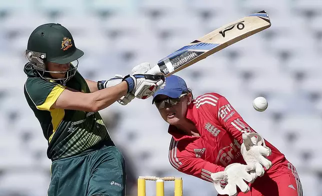 FILE - England's Sarah Taylor, right, ducks out of the way as Australia's Alyssa Healy plays a shot in their WT20 cricket match during the Women's Ashes series in Sydney, Australia, Sunday, Feb. 2, 2014. (AP Photo/Rob Griffith, File)