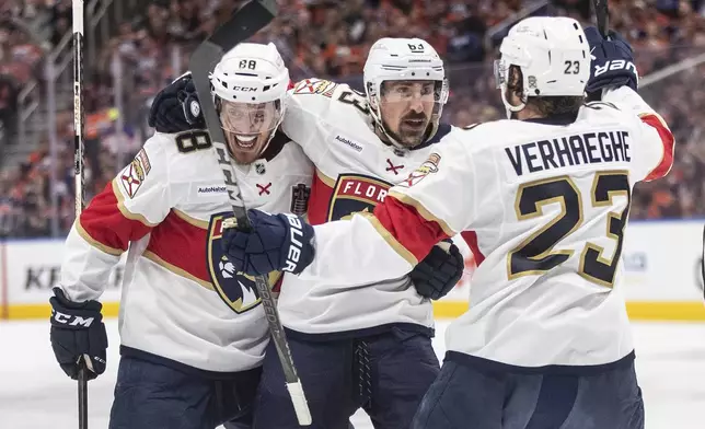Florida Panthers' Nate Schmidt (88), Brad Marchand (63) and Carter Verhaeghe (23) celebrate a goal against the Edmonton Oilers' during the first period in Game 1 of the NHL Stanley Cup final in Edmonton, Alberta, Wednesday, June 4, 2025. (Jason Franson/The Canadian Press via AP)