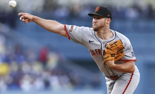 San Francisco Giants pitcher Landen Roupp (65) delivers to a Los Angeles Dodgers batter during the first inning of a baseball game in Los Angeles, Saturday, June 14, 2025. (AP Photo/Jessie Alcheh)
