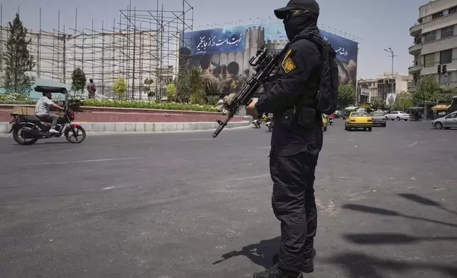 A member of Iran's Revolutionary Guard stands guard at Enqelab-e-Eslami (Islamic Revolution) square in downtown Tehran, Iran, Tuesday, June 24, 2025. (AP Photo/Vahid Salemi)
