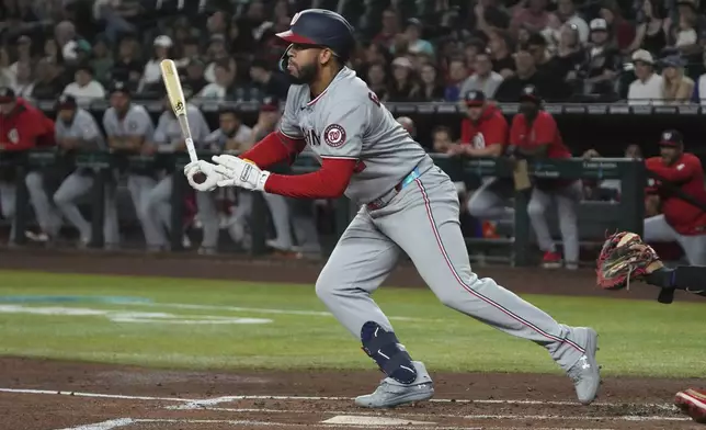 Washington Nationals' Luis García Jr. hits a two-run double against the Arizona Diamondbacks in the first inning during a baseball game, Saturday, May 31, 2025, in Phoenix. (AP Photo/Rick Scuteri)
