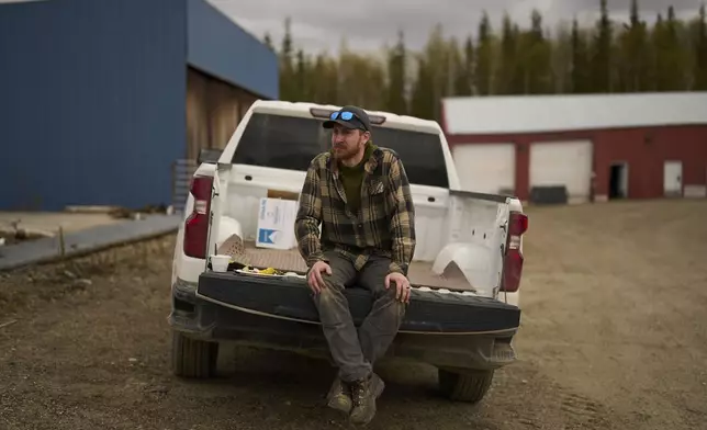 Will Kramer, Applied Mechanics instructor at the Galena Interior Learning Academy, sits on the bed of a truck Wednesday, May 21, 2025, in Galena, Alaska. (AP Photo/John Locher)