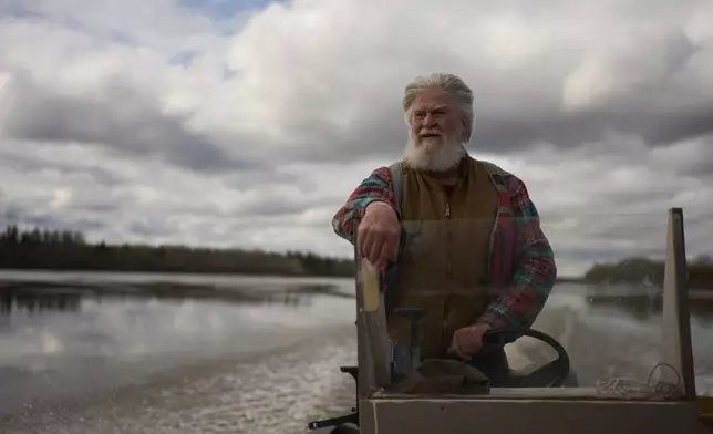 Phil Koontz drives his boat on the Yukon River, Wednesday, May 21, 2025, in Galena, Alaska. (AP Photo/John Locher)