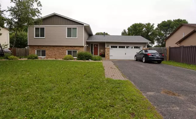 Bullet holes mark the front door of the house of Minnesota state Sen. John Hoffman and his wife who were shot earlier in the day, Saturday, June 14, 2025, in Champlin, Minn. (AP Photo/Bruce Kluckhohn)