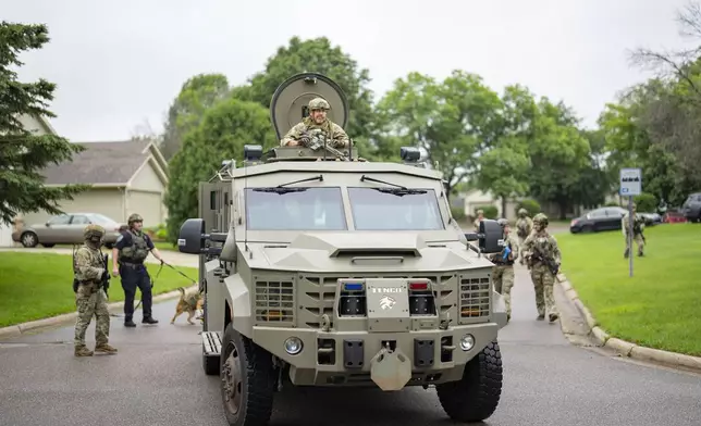 Armed FBI agents search for an active shooter, sweeping a neighborhood adjacent to the home of Minnesota DFL State Representative Melissa Hortman, in Brooklyn Park, Minn., Saturday, June 14, 2025. (Alex Kormann/Star Tribune via AP)
