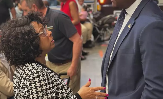 Tulsa Mayor Monroe Nichols speaks to North Tulsa resident Jacqueline Weary, a descendant of a Tulsa Race Massacre survivor, on Thursday, May 22, 2025. (AP Photo/Sean Murphy