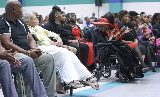 Viola "Mother" Ford Fletcher, 110 years of age (yellow) is one of the final two survivors sits across the aisle from the other survivor Lessie Benningfield "Mother" Randle (red hat), 109 years old, as they listen during the Legacy event for the Tulsa Race Massacre on Sunday, June 1, 2025, at Greenwood Cultural Center in Tulsa, Okla. (AP Photo/Joey Johnson)