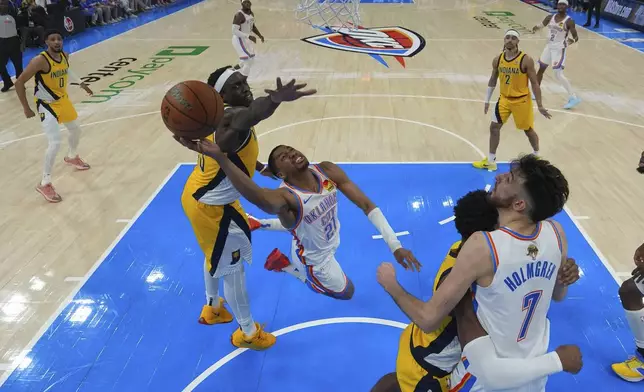 Oklahoma City Thunder guard Aaron Wiggins (21) shoots past Indiana Pacers forward Pascal Siakam (43) during the second half of Game 5 of the NBA Finals basketball series, Monday, June 16, 2025, in Oklahoma City. (AP Photo/Nate Billings)