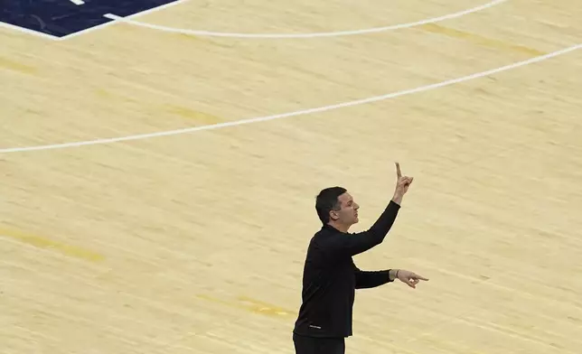 Oklahoma City Thunder head coach Mark Daigneault make a call during the first half of Game 6 of the NBA Finals basketball series against the Indiana Pacers, Thursday, June 19, 2025, in Indianapolis. (AP Photo/Abbie Parr)