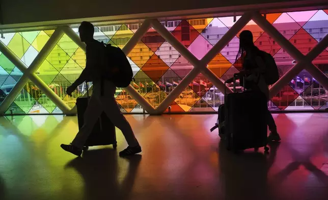 Travellers arrive at Miami International Airport, Thursday, June 5, 2025, in Miami, Fla. (AP Photo/Marta Lavandier)