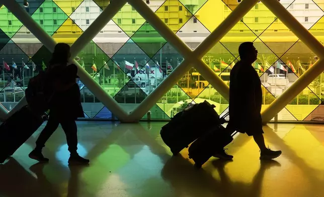 Travellers arrive at Miami International Airport, Thursday, June 5, 2025, in Miami, Fla. (AP Photo/Marta Lavandier)