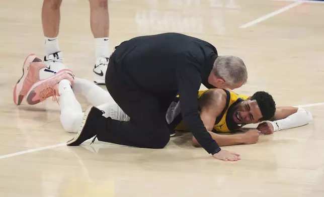 Indiana Pacers guard Tyrese Haliburton lays on the court after an injury during the first half of Game 7 of the NBA Finals basketball series against the Oklahoma City Thunder Sunday, June 22, 2025, in Oklahoma City. (AP Photo/Nate Billings)