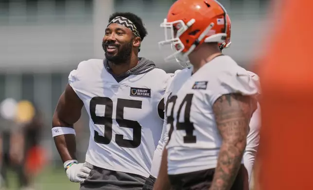 Cleveland Browns defensive end Myles Garrett (95) and defensive tackle Mason Graham (94) are pictured at NFL football minicamp in Berea, Ohio, Tuesday, June 10, 2025. (AP Photo/Sue Ogrocki)