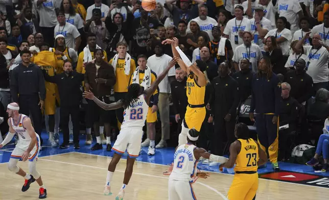 Indiana Pacers guard Tyrese Haliburton (0) shoots a 3-pointer against Oklahoma City Thunder guard Cason Wallace (22) during the second half of Game 1 of the NBA Finals basketball series Thursday, June 5, 2025, in Oklahoma City. (AP Photo/Nate Billings)