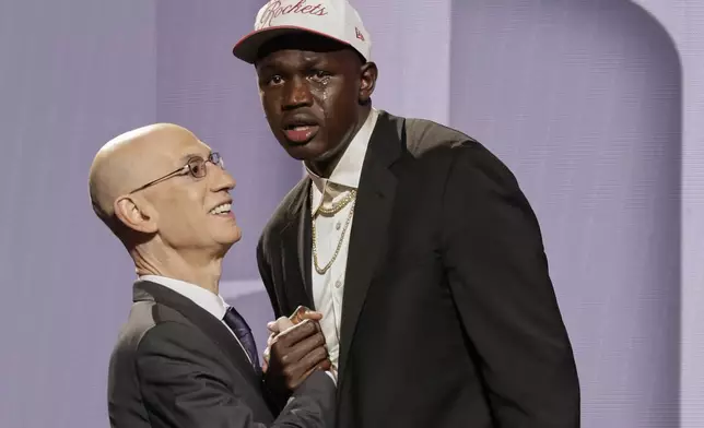 Khaman Maluach reacts as he greets NBA commissioner Adam Silver after being selected 10th by the Houston Rockets in the first round of the NBA basketball draft, Wednesday, June 25, 2025, in New York. (AP Photo/Adam Hunger)