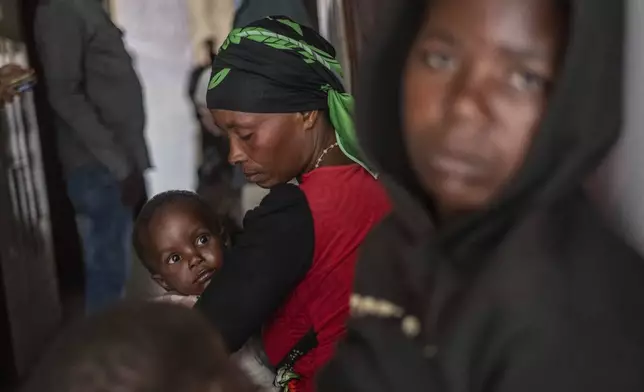 Residents listen to Tom Fletcher, Under-Secretary-General for Humanitarian Affairs and Emergency Relief Coordinator at the Office for the Coordination of Humanitarian Affairs (OCHA), during his visit to North Kivu's town of Buhumba, Democratic republic of the Congo, Thursday, June 26, 2025. (AP Photo/Moses Sawasawa)