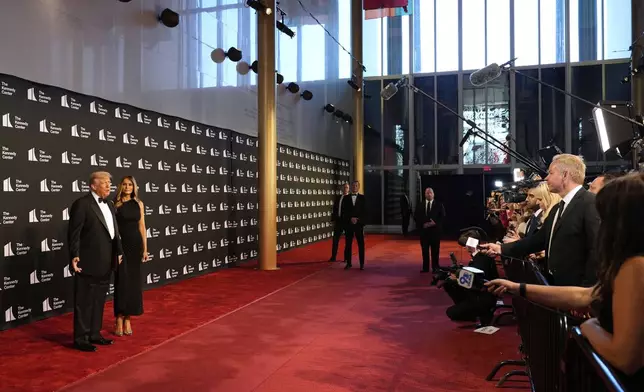 President Donald Trump and first lady Melania Trump arrive to view opening night of "Les Miserables," at the Kennedy Center, Wednesday, June 11, 2025, in Washington. (AP Photo/Alex Brandon)