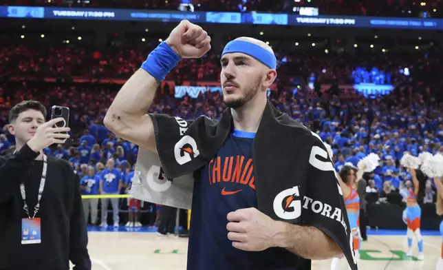 Oklahoma City Thunder's Alex Caruso celebrates as he walks off the court after the team's win against the Denver Nuggets in Game 7 in the Western Conference semifinals of the NBA basketball playoffs, Sunday, May 18, 2025, in Oklahoma City. (AP Photo/Kyle Phillips)