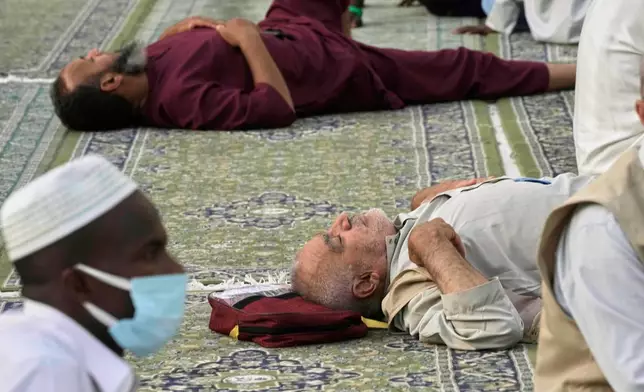 Muslim pilgrims take a nap at the Grand Mosque during the annual Hajj pilgrimage, in Mecca, Saudi Arabia, Tuesday, June 3, 2025. (AP Photo/Amr Nabil)