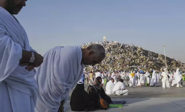 Muslim pilgrims offer prayers at top of the rocky hill known as the Mountain of Mercy, on the Plain of Arafat, during the annual Hajj pilgrimage near the holy city of Mecca, Saudi Arabia, Thursday, June 5, 2025. (AP Photo/Amr Nabil)