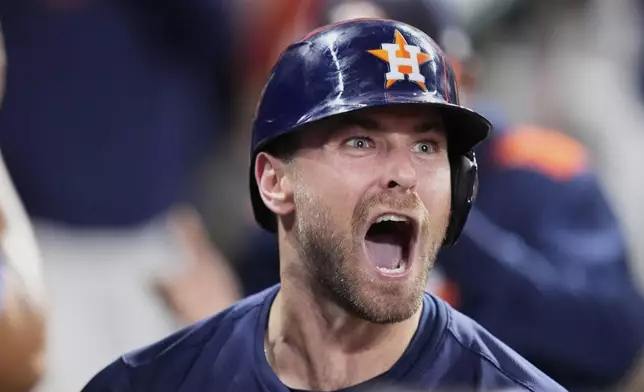 Houston Astros' Cooper Hummel celebrates in the dugout after hitting a home run against the Philadelphia Phillies during the eighth inning of a baseball game Tuesday, June 24, 2025, in Houston. (AP Photo/David J. Phillip)