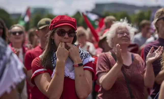 Tens of thousands of red-clad protesters march demanding their government do more to halt Israel's campaign in Gaza, during a demonstration in The Hague, Netherlands, Sunday, June 15, 2025. (AP Photo/Peter Dejong)