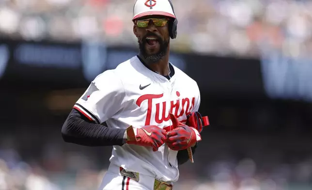 Minnesota Twins' Byron Buxton looks on after drawing a walk by Milwaukee Brewers starting pitcher Jose Quintana during the first inning of a baseball game Saturday, June 21, 2025, in Minneapolis. (AP Photo/Bailey Hillesheim)