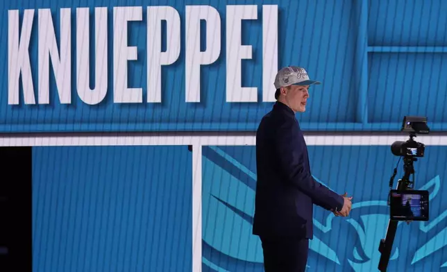 Kon Knueppel walks up on stage after being selected fourth by the Charlotte Hornets In the first round of the NBA basketball draft, Wednesday, June 25, 2025, in New York. (AP Photo/Adam Hunger)