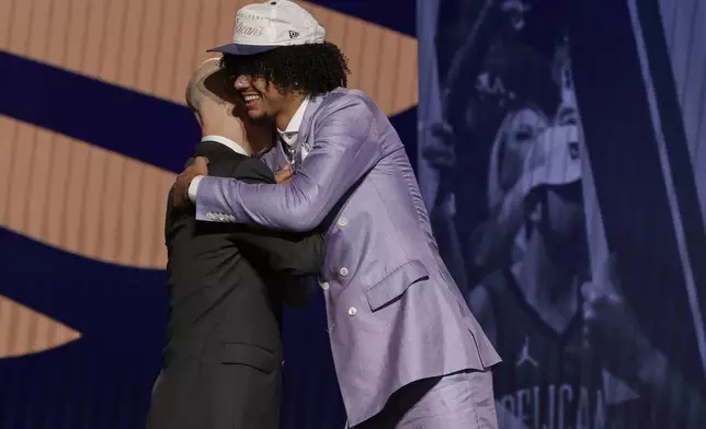 Asa Newell hugs NBA commissioner Adam Silver after being selected 23rd by the New Orleans Pelicans in the first round of the NBA basketball draft, Wednesday, June 25, 2025, in New York. (AP Photo/Adam Hunger)