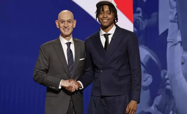 Trę Johnson poses for a photo with NBA commissioner Adam Silver after being selected sixth by the Washington Wizards in the first round of the NBA basketball draft, Wednesday, June 25, 2025, in New York. (AP Photo/Adam Hunger)