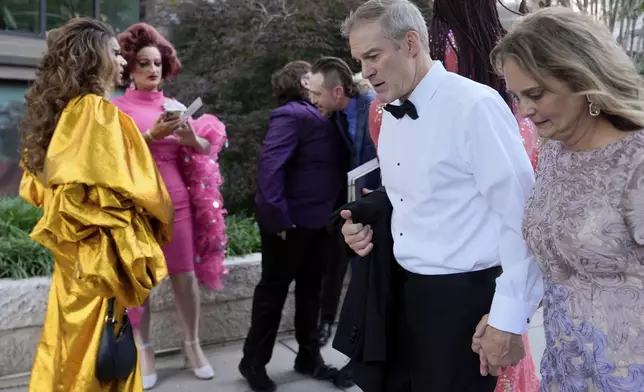 Rep. Jim Jordan, R-Ohio, and Polly Jordan walk past Tara Hoot, Ricky Rosé, Vagenesis and Maria Con Carne outside the Kennedy Center, to attend Les Miserables, Wednesday, June 11, 2025, in Washington, on the night that President Donald Trump and first lady Melania Trump were also attending. (AP Photo/Julia Demaree Nikhinson)