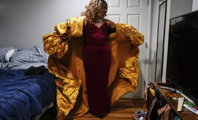 Mari Con Carne puts on their coat before attending Les Miserables at the Kennedy Center in drag, on the night that President Donald Trump and first lady Melania Trump were also in attendance, Wednesday, June 11, 2025, in Washington. (AP Photo/Julia Demaree Nikhinson)