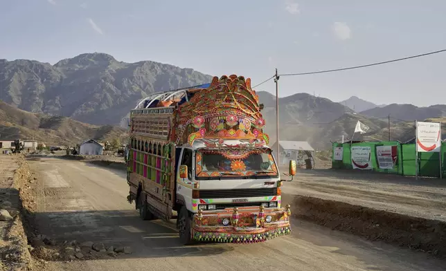 A Pakistani truck carrying repatriated Afghan refugees arrives at a camp near the Pakistan-Afghanistan border, in Torkham, Afghanistan, Saturday, May 31, 2025. (AP Photo/Ebrahim Noroozi)